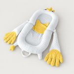 Yellow chick soothing patting Yorkie bed